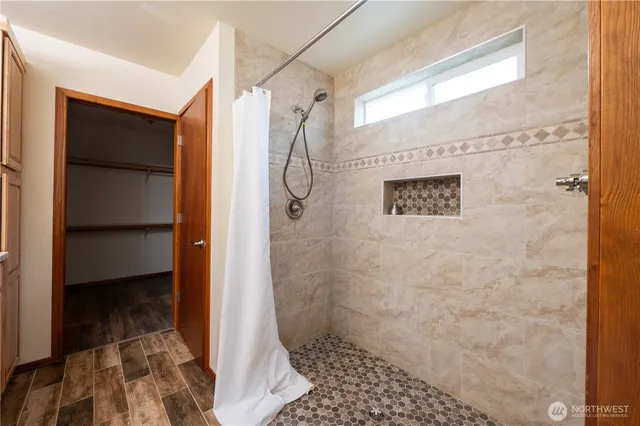 a bathroom with a shower and a sink