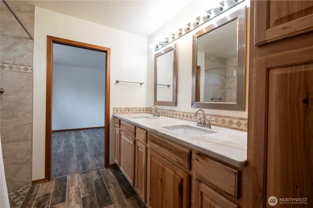 a bathroom with a granite countertop sink and a mirror