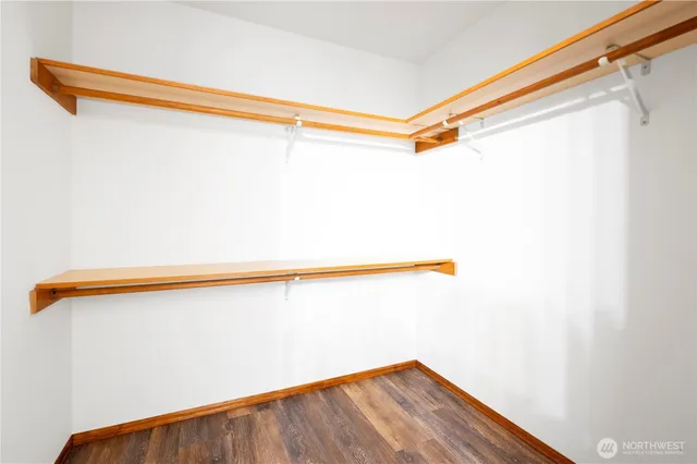 a view of a room with wooden floor and a window