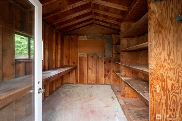 a view of a house with a yard and a tree