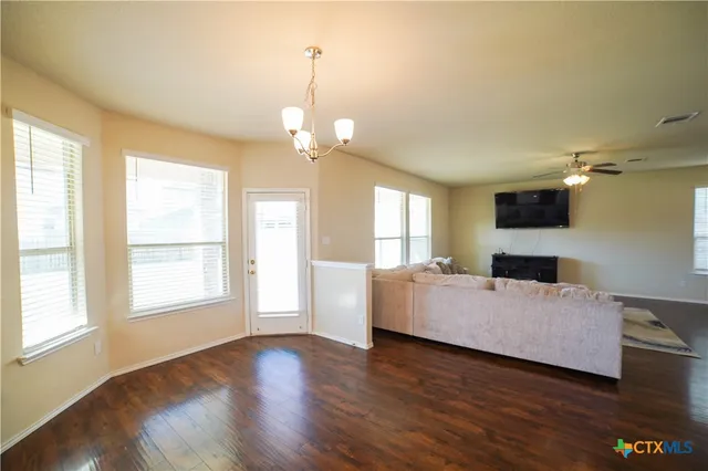 a living room with hard wood floors and a window