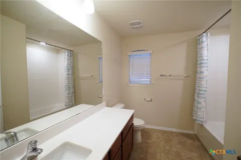 a bathroom with a sink and shower