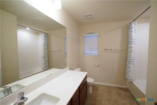 a bathroom with a sink and shower