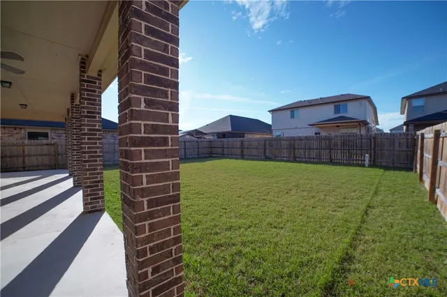 a view of a house with a yard and sitting area