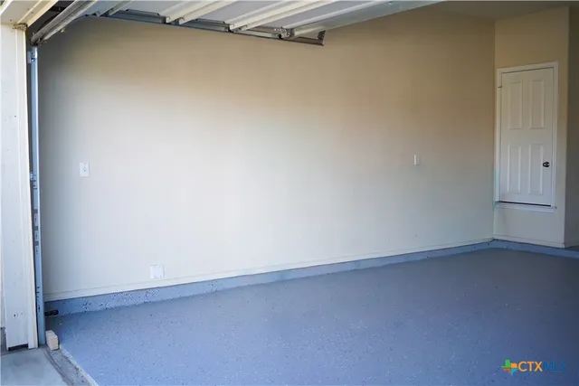 a view of an empty room and floor to ceiling window