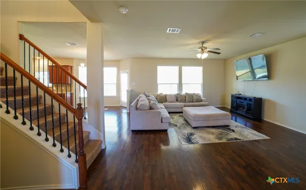 a living room with furniture and wooden floor