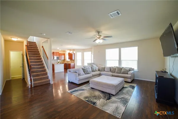 a living room with fireplace furniture and a flat screen tv