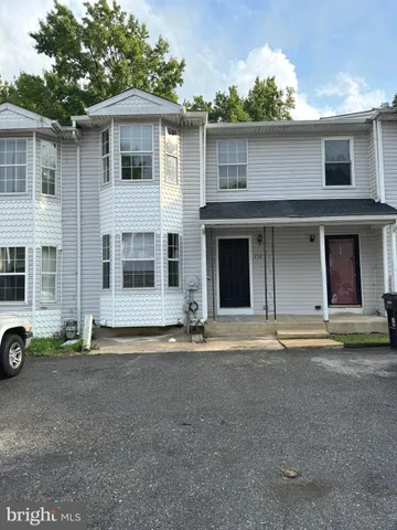 a front view of a house with a road