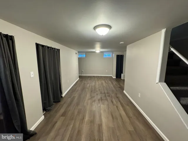 a view of hallway with wooden floor