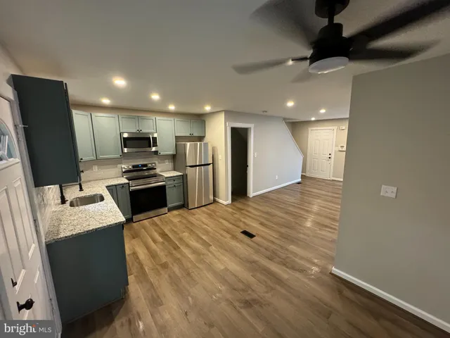 a kitchen with stainless steel appliances a refrigerator sink and stove