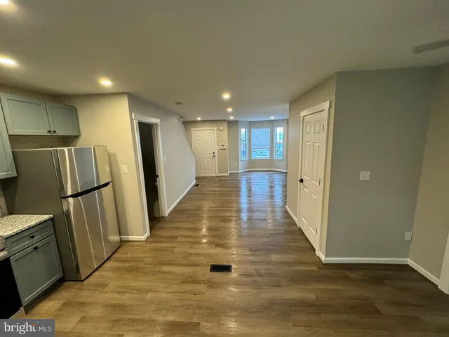 a view of a hallway with wooden floor
