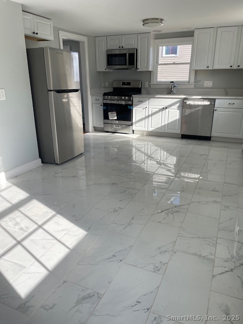 156 Triangle Street Danbury, CT 06810 - Photo 4 of 14 a kitchen with granite countertop a refrigerator and a sink
