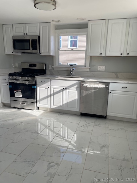 156 Triangle Street Danbury, CT 06810 - Photo 5 of 14 a kitchen with stainless steel appliances granite countertop a stove a sink and a microwave