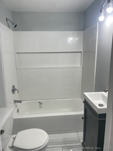 156 Triangle Street Danbury, CT 06810 - Photo 7 of 14 a bathroom with a sink a toilet and a bathtub