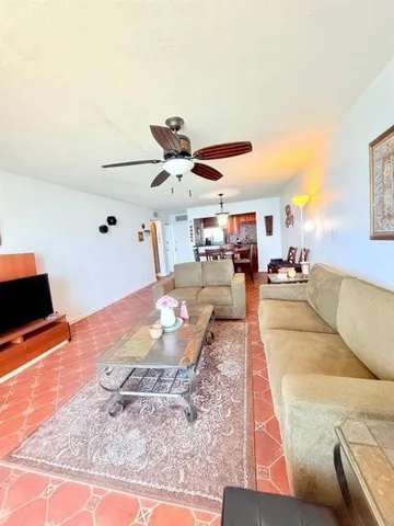 a living room with furniture kitchen view and a table