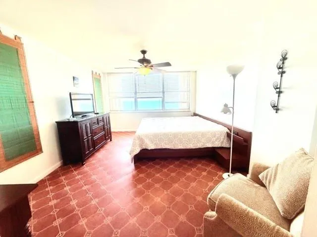 a bedroom with a bed and a mirror