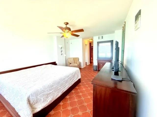 a bedroom with a bed and a couch