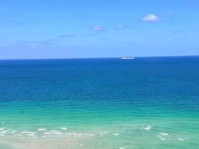 a living room with stainless steel appliances kitchen island granite countertop a sink and cabinets