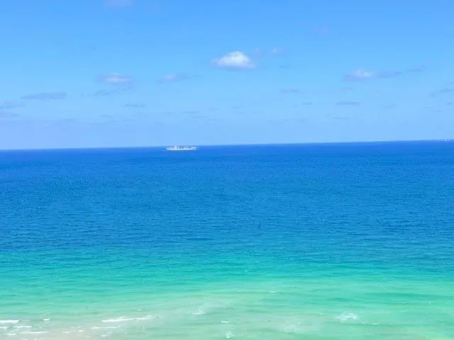 a view of a patio with dining table and chairs with a small yard