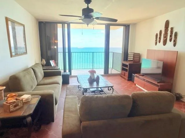 a living room with furniture a window and a table