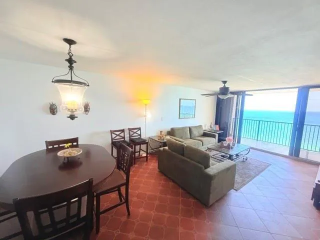 a living room with furniture a chandelier and a window
