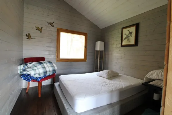 a living room with furniture and a table next to a large window