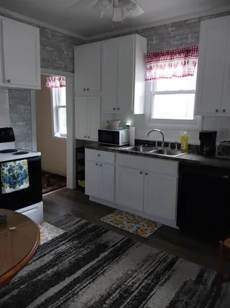 a kitchen with a sink stove and cabinets
