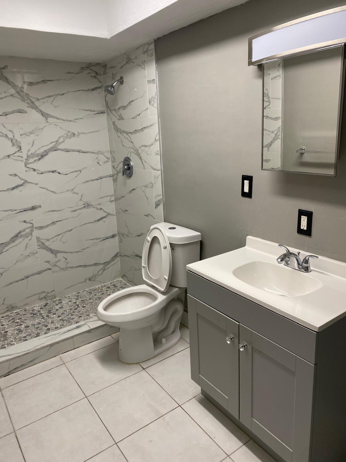 1195 Northwest 16th Avenue, Unit 10 Boca Raton, FL 33486 - Photo 5 of 13 a bathroom with a toilet sink and mirror