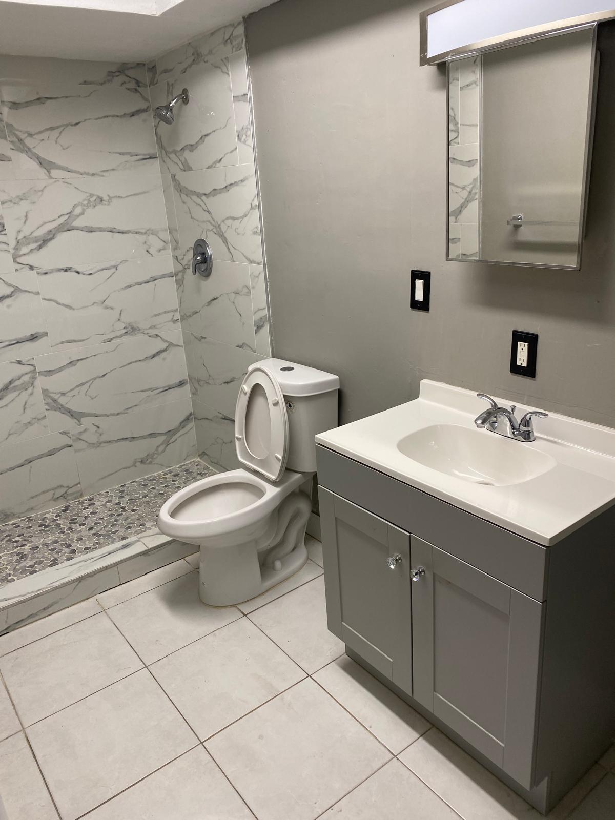 1195 Northwest 16th Avenue, Unit 10 Boca Raton, FL 33486 - Photo 6 of 13 a bathroom with a sink toilet and mirror