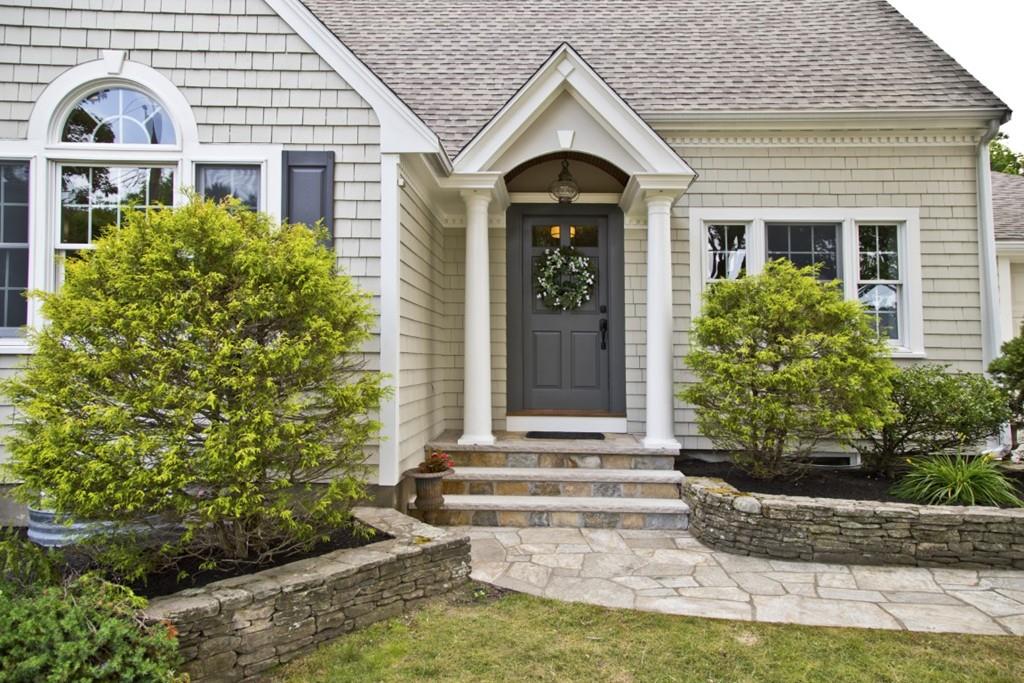 10 Bainbridge Road Reading, MA 01867 - Photo 2 of 3 a front view of a house with garden