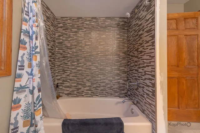 a bathroom with a bathtub and shower