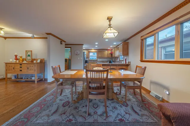 a dining room with furniture a rug and wooden floor