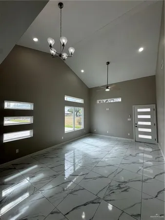 a view of an empty room with a window and fireplace