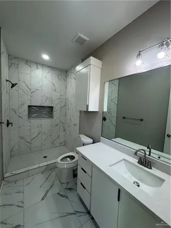 a bathroom with a sink toilet and shower