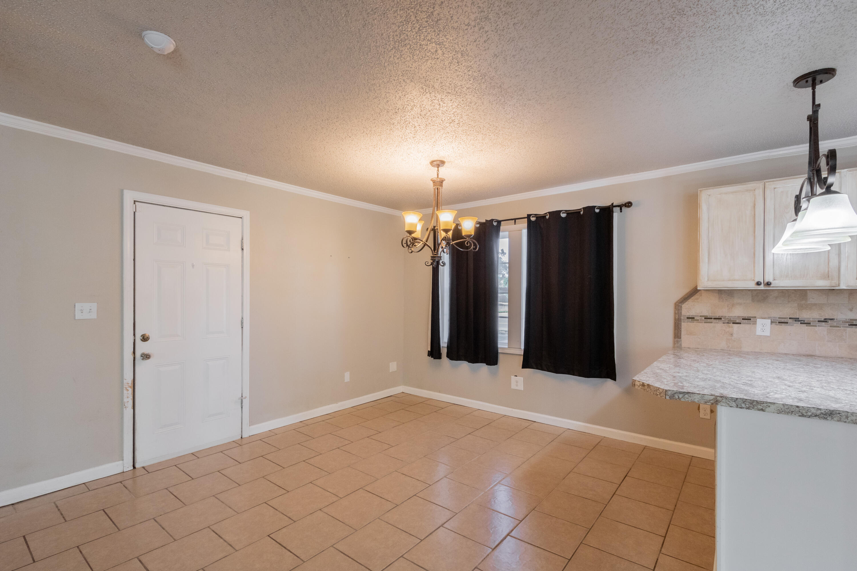 4021 38th Street Lubbock, TX 79413 - Photo 11 of 32 a view of a kitchen with a sink and a refrigerator