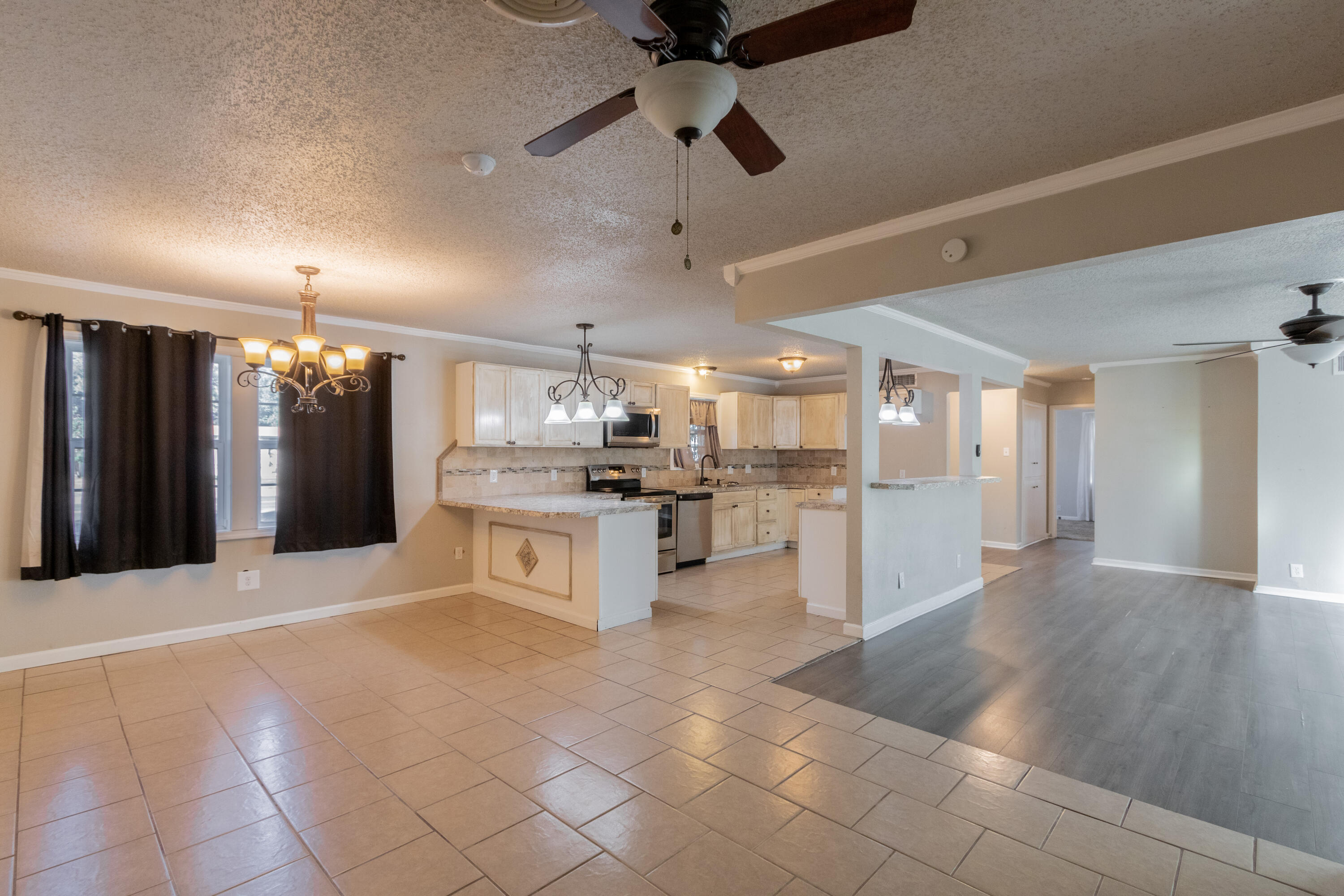 4021 38th Street Lubbock, TX 79413 - Photo 13 of 32 a large kitchen with a large counter top stainless steel appliances and cabinets