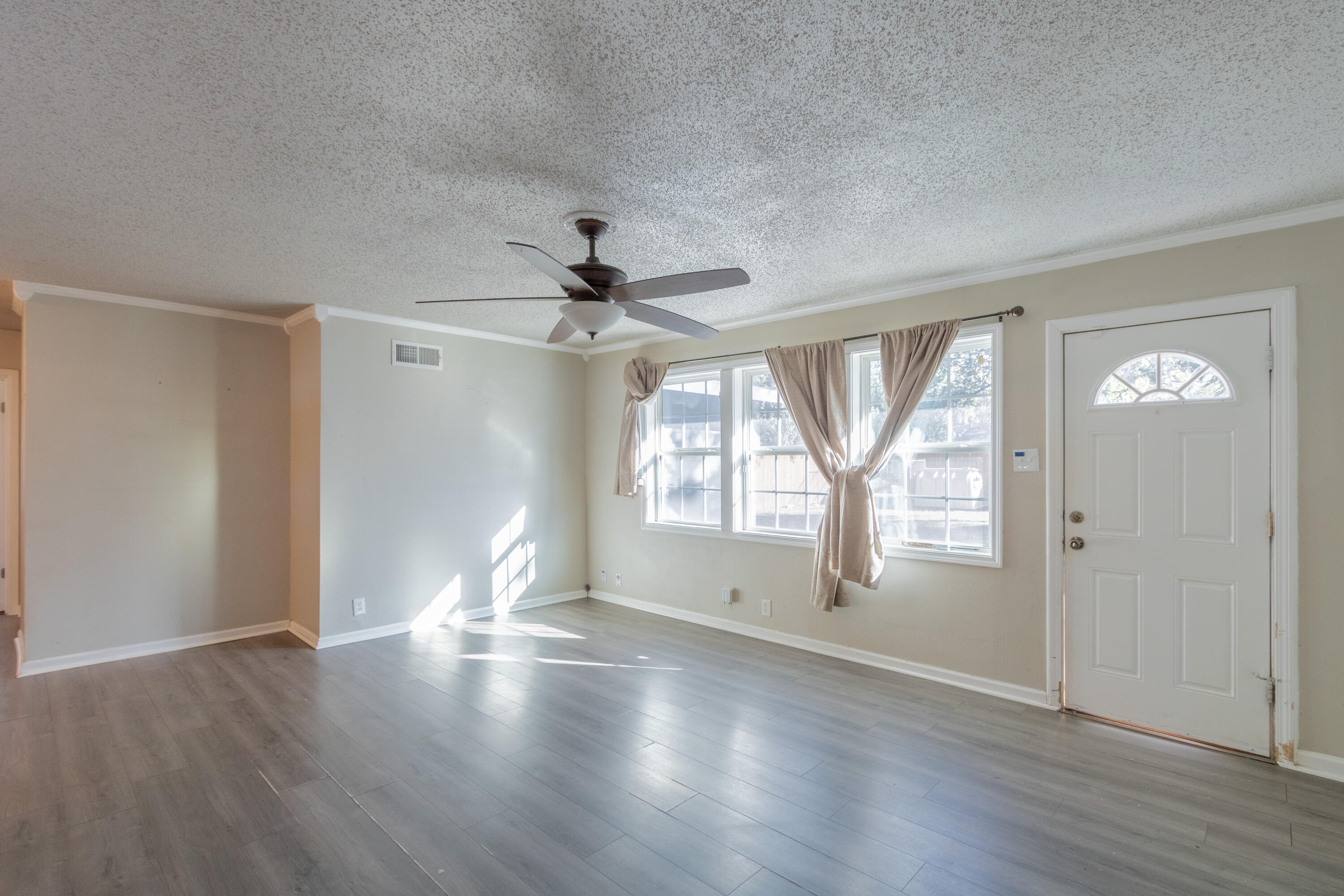 4021 38th Street Lubbock, TX 79413 - Photo 14 of 32 a view of empty room with wooden floor and fan