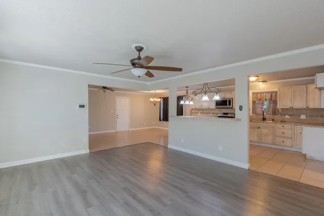 a view of a kitchen with a sink and wooden floor