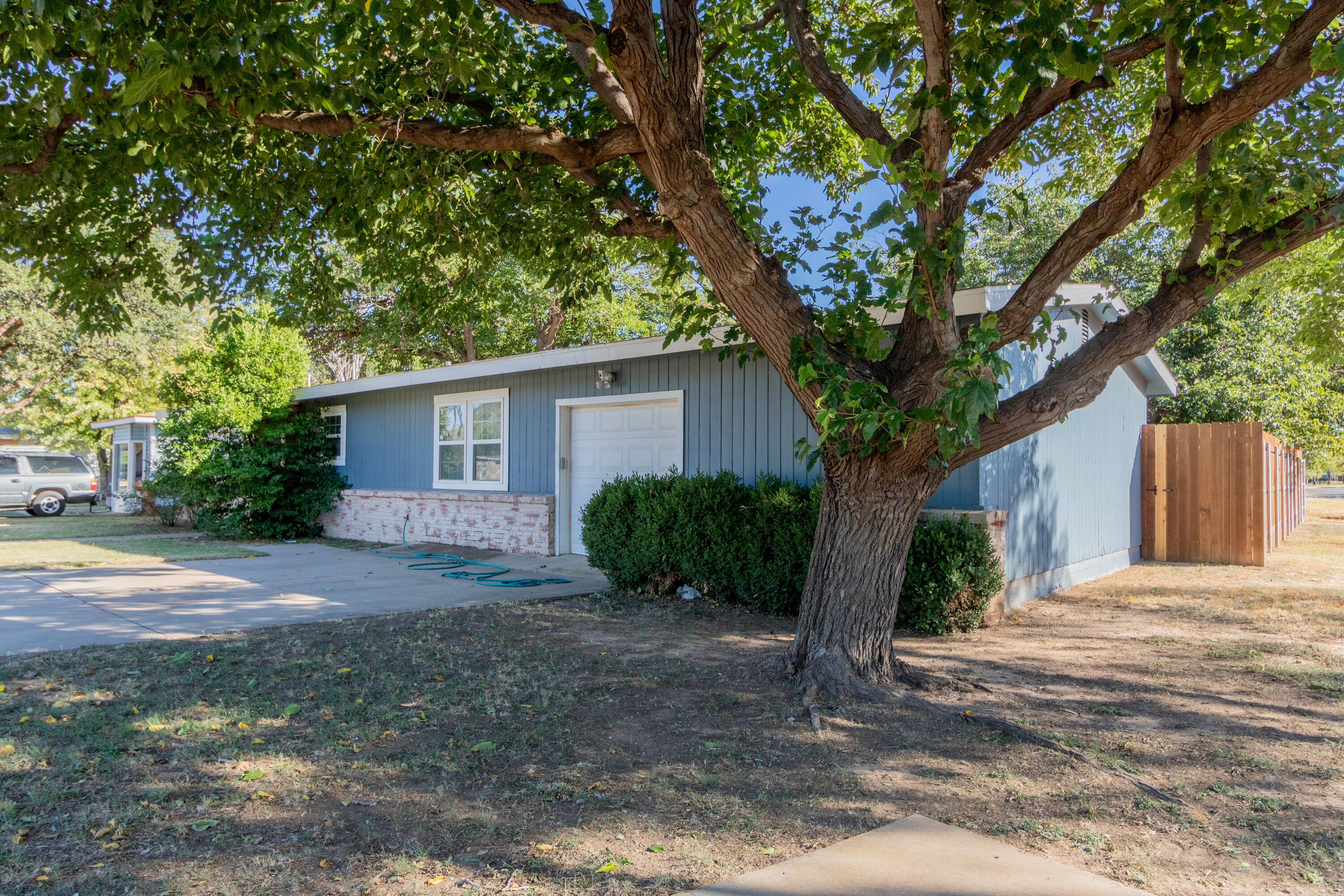 4021 38th Street Lubbock, TX 79413 - Photo 2 of 32 a view of a house with a tree in front of it