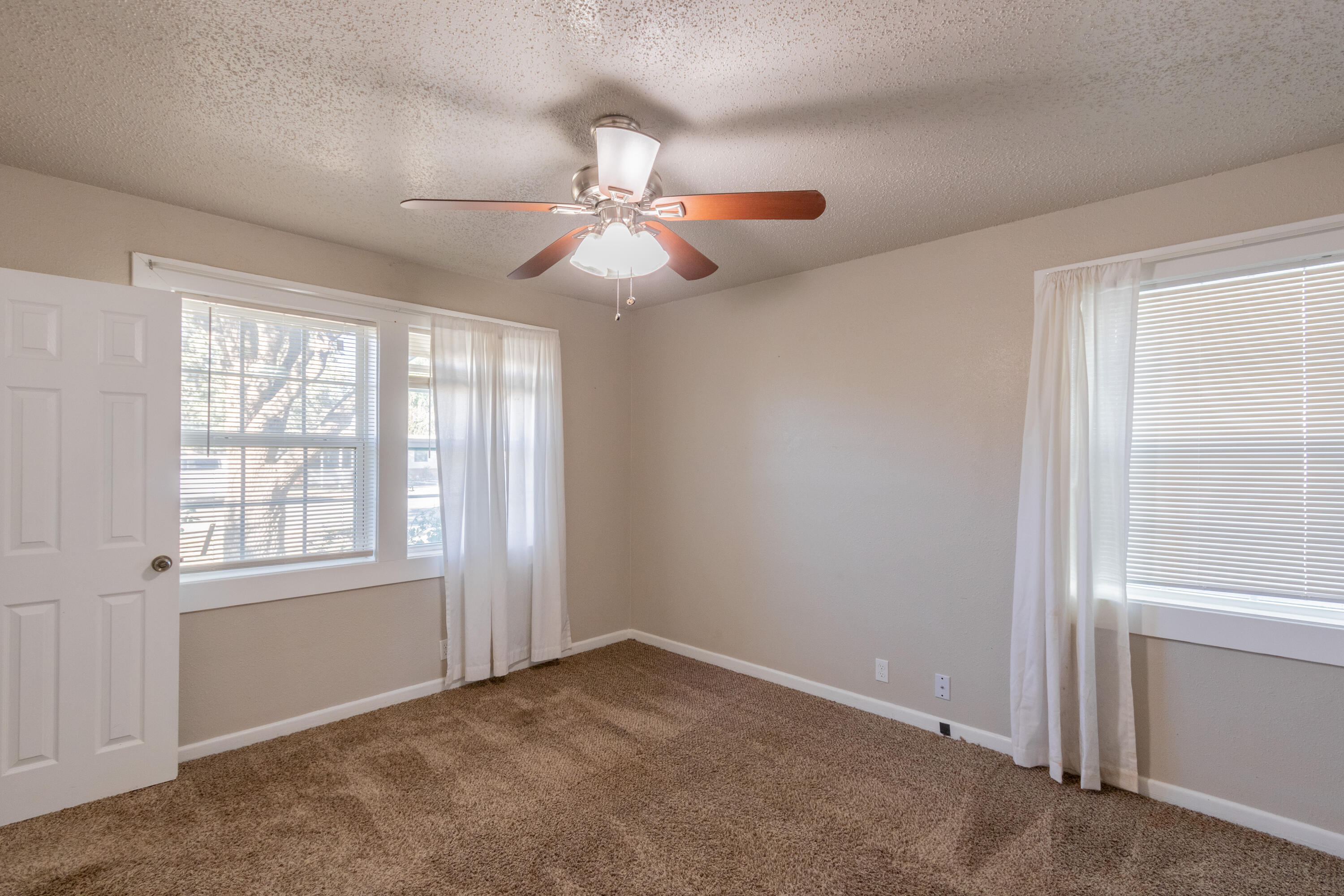 4021 38th Street Lubbock, TX 79413 - Photo 21 of 32 an empty room with windows and fan