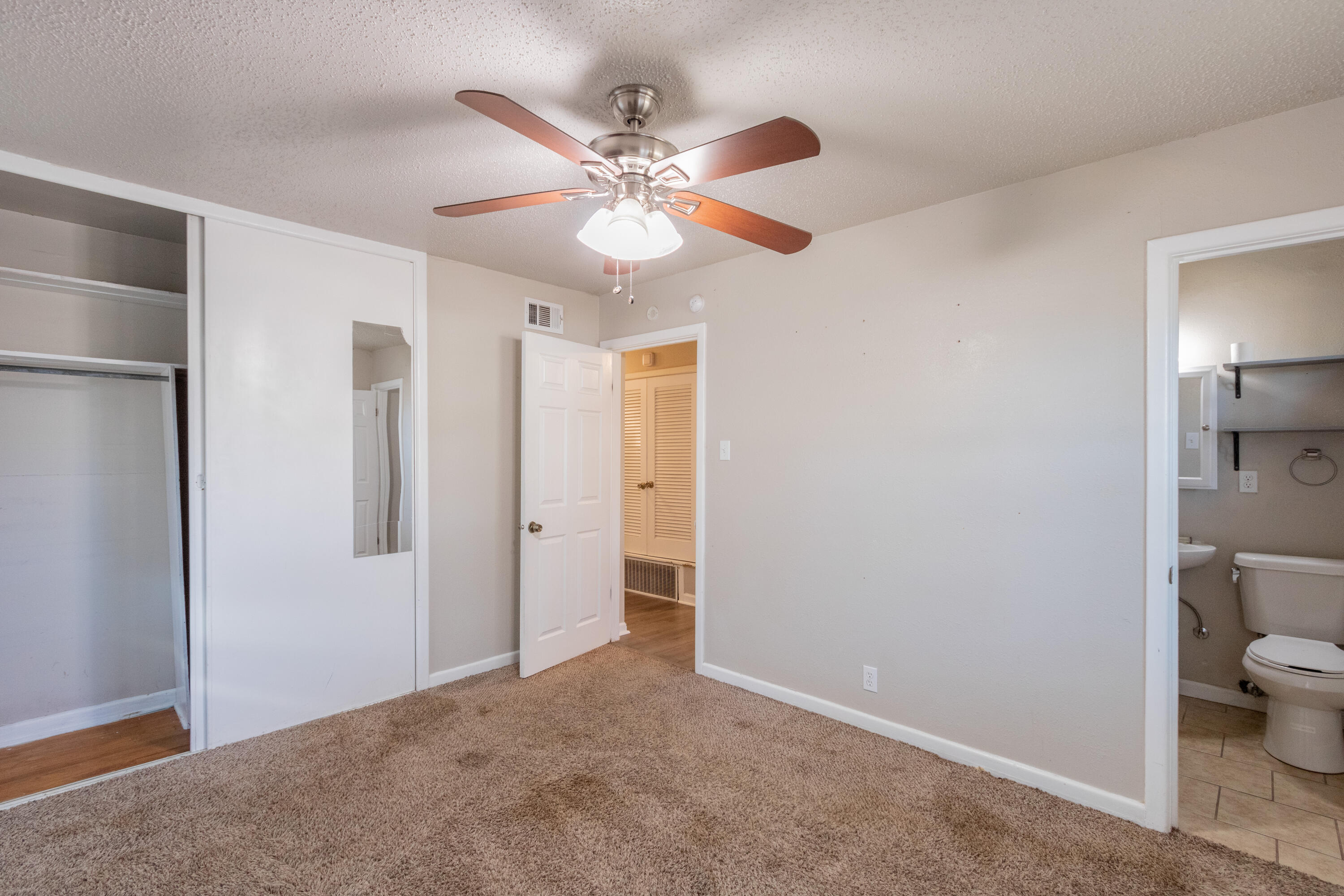 4021 38th Street Lubbock, TX 79413 - Photo 22 of 32 a view of a room with a ceiling fan and a bathroom