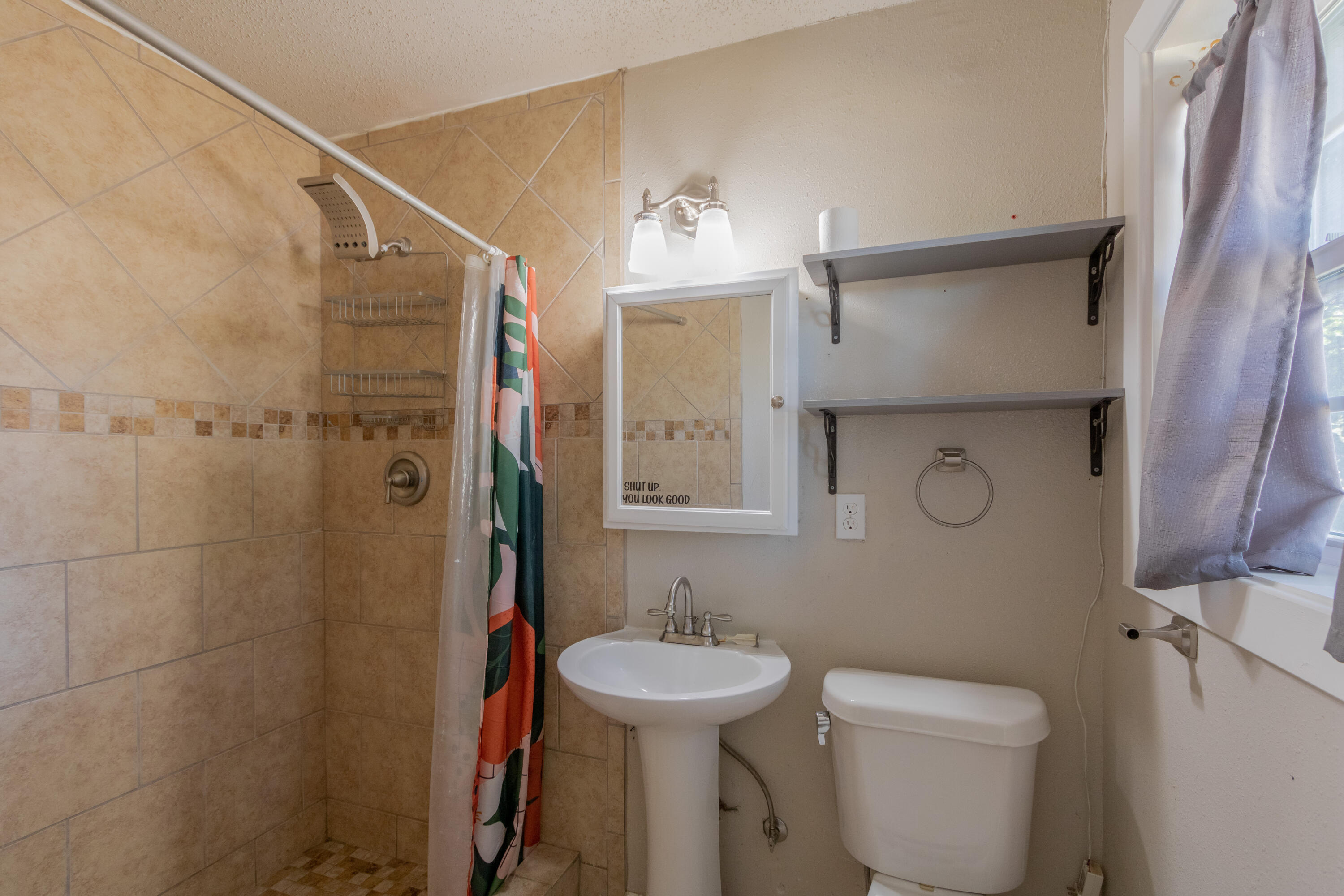 4021 38th Street Lubbock, TX 79413 - Photo 23 of 32 a bathroom with a toilet sink and shower