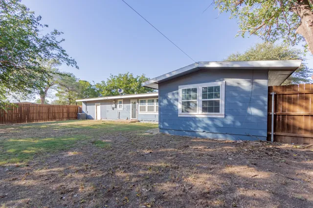 a view of a house with yard and a garden