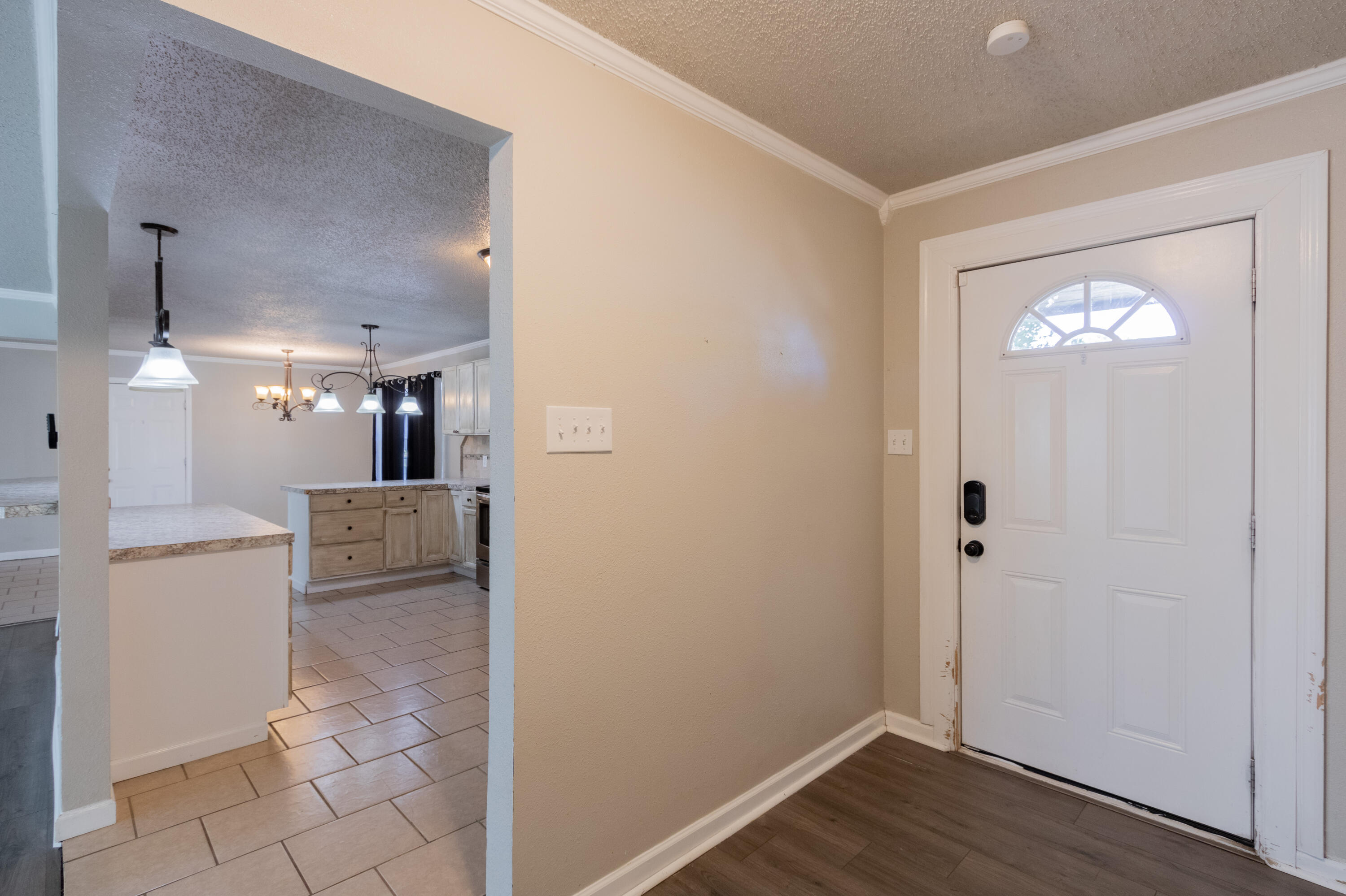 4021 38th Street Lubbock, TX 79413 - Photo 5 of 32 a view of a hallway with wooden floor and a bathroom