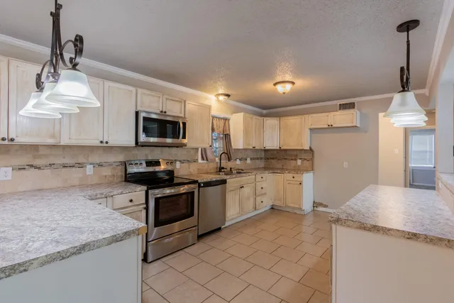 a kitchen with granite countertop white cabinets and white appliances