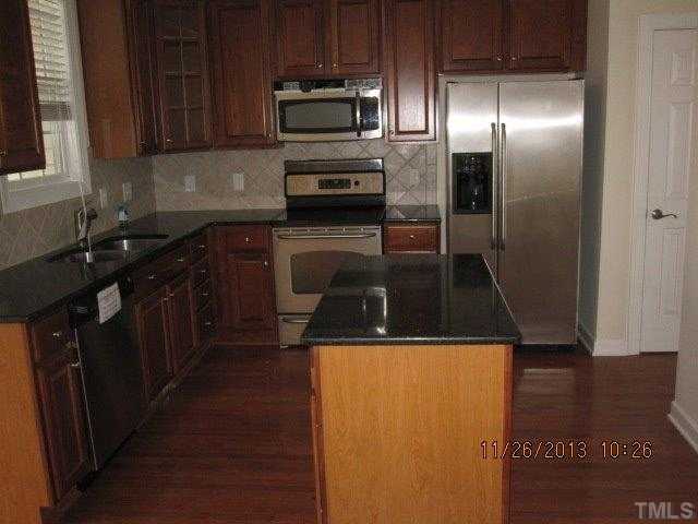 3122 Kentish Town Lane Raleigh, NC 27612 - Photo 3 of 11 a kitchen with a sink a microwave and cabinets