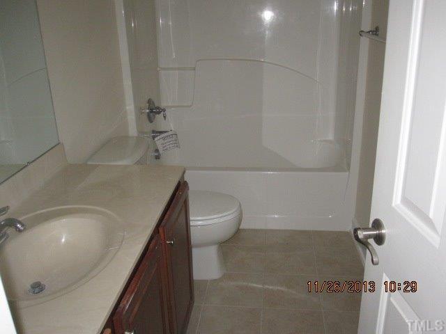 3122 Kentish Town Lane Raleigh, NC 27612 - Photo 10 of 11 a bathroom with a sink a toilet and tub