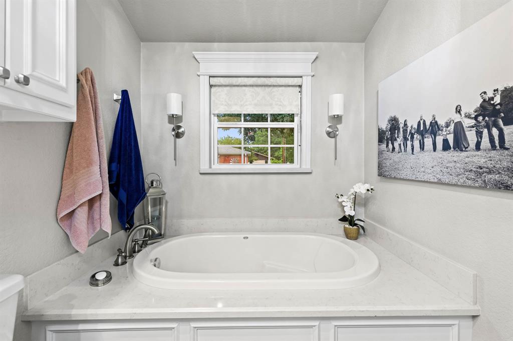 934 North Maple Street Muenster, TX 76252 - Photo 16 of 39 a bathroom with a sink and a bathtub