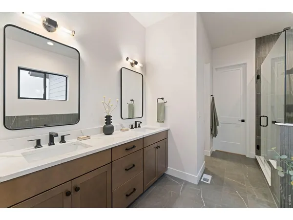a bathroom with a double vanity sink mirror and double