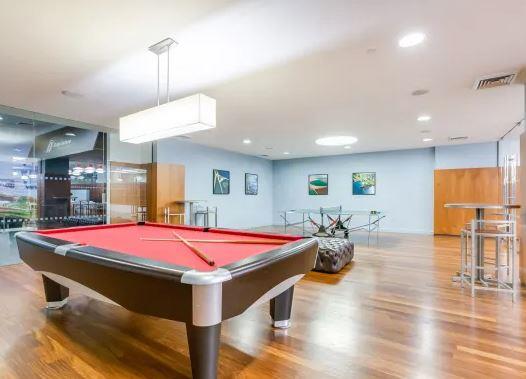 60 Riverside Boulevard, Unit 623 Manhattan, NY 10069 - Photo 11 of 12 a dining hall with a dining table chairs with wooden floor and chandelier